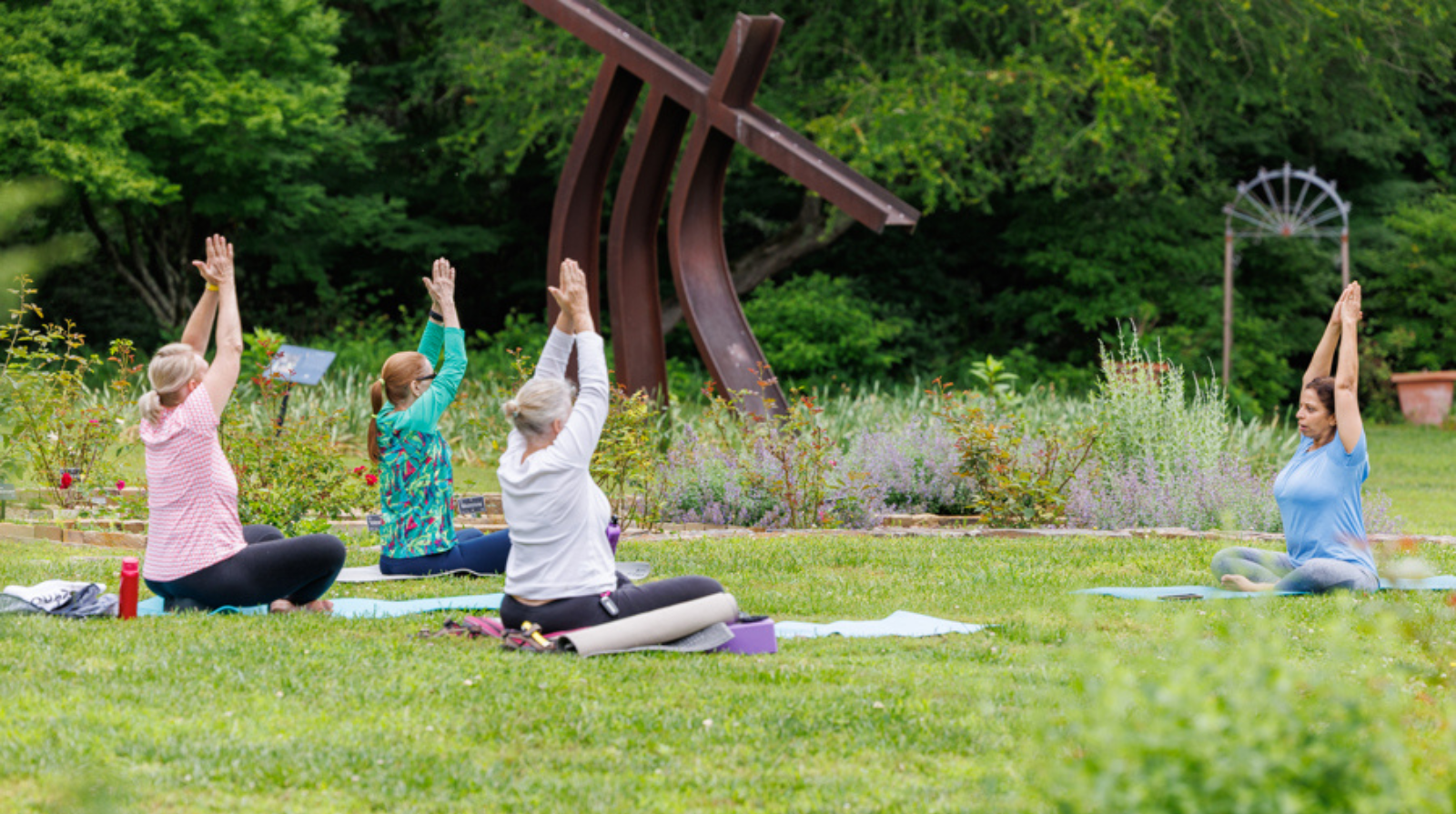A yoga class taking place in a garden