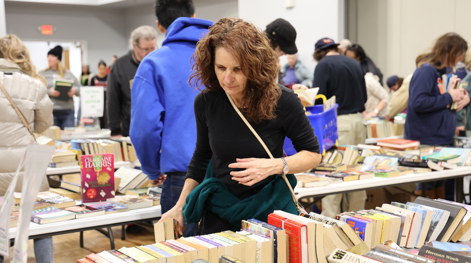 A woman browsing through books at the book swap.
