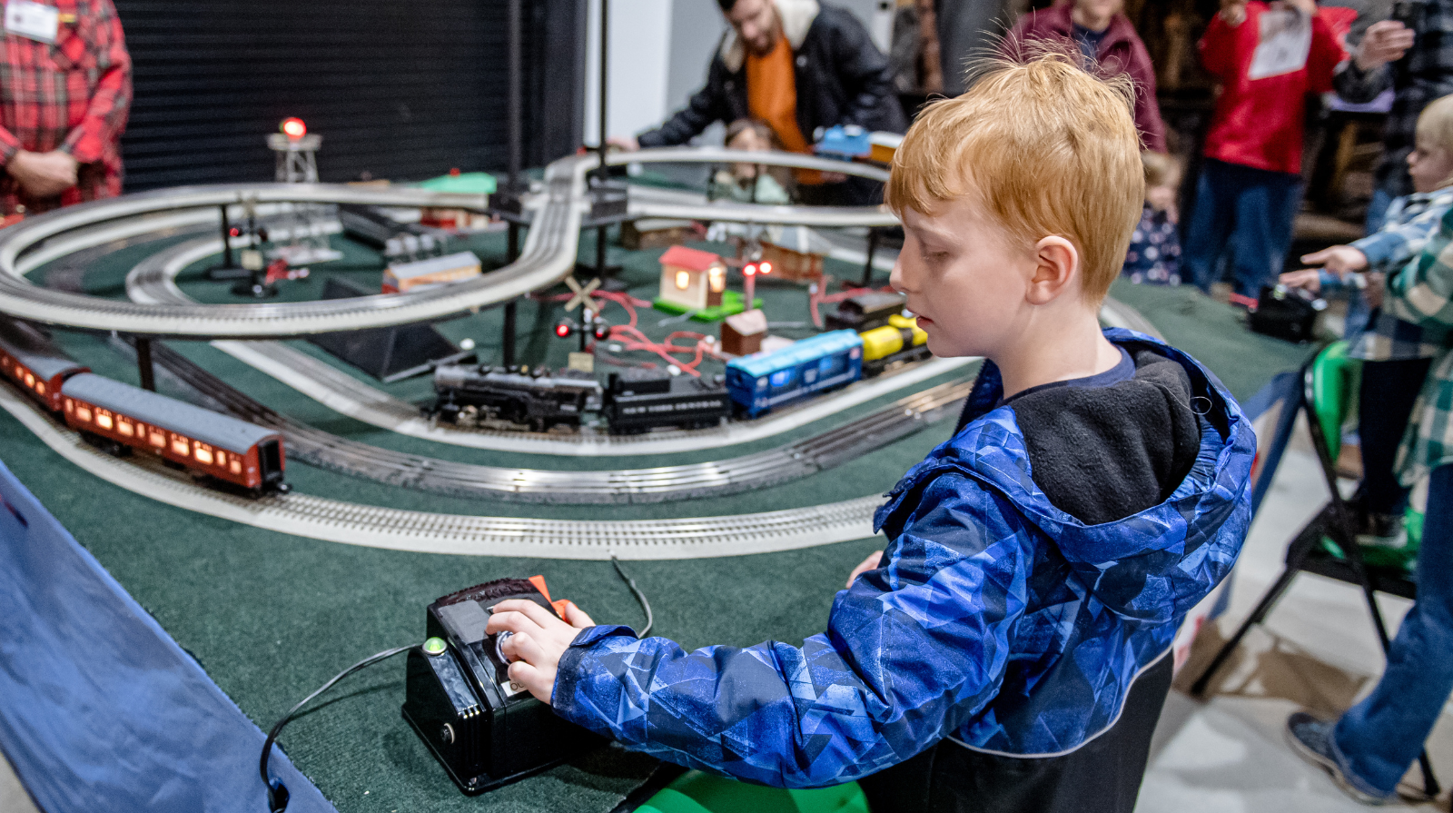 At the Southern Museum, a young boy engages with a model train set, exploring the detailed train layout.