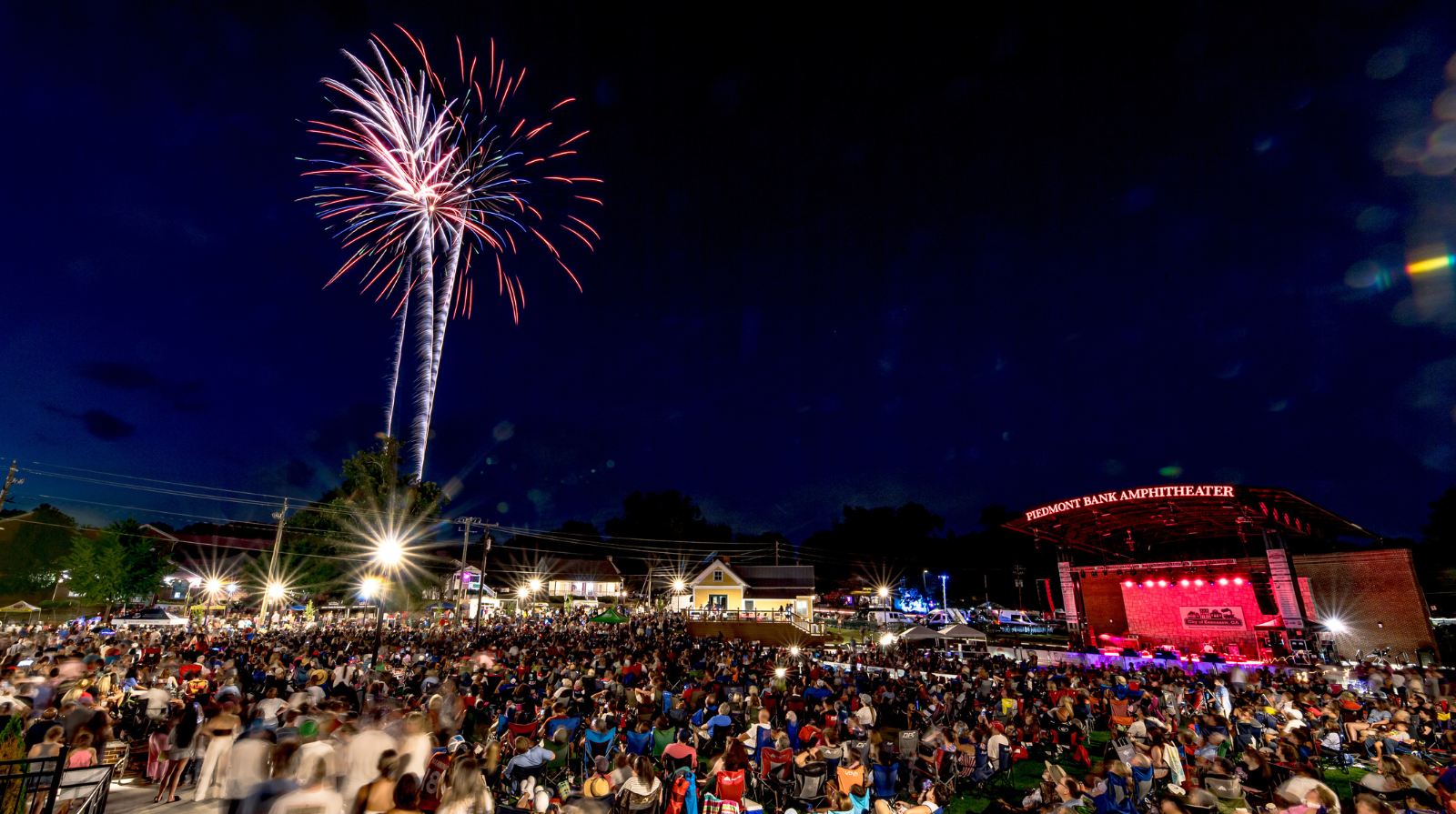 Spectators in Kennesaw enjoy a vibrant fireworks display at night during the Salute to America event.