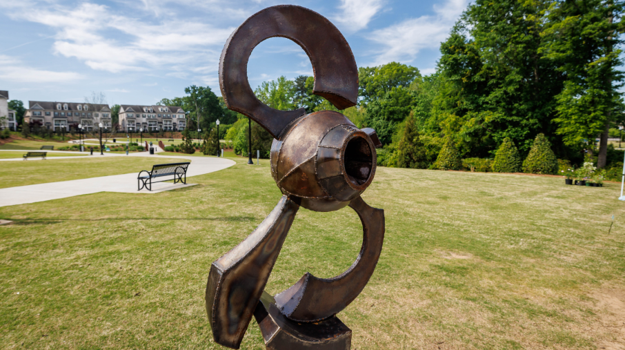 A large sculpture displayed at Depot Park, part of the Art Blooms exhibit, showcasing contemporary outdoor art.