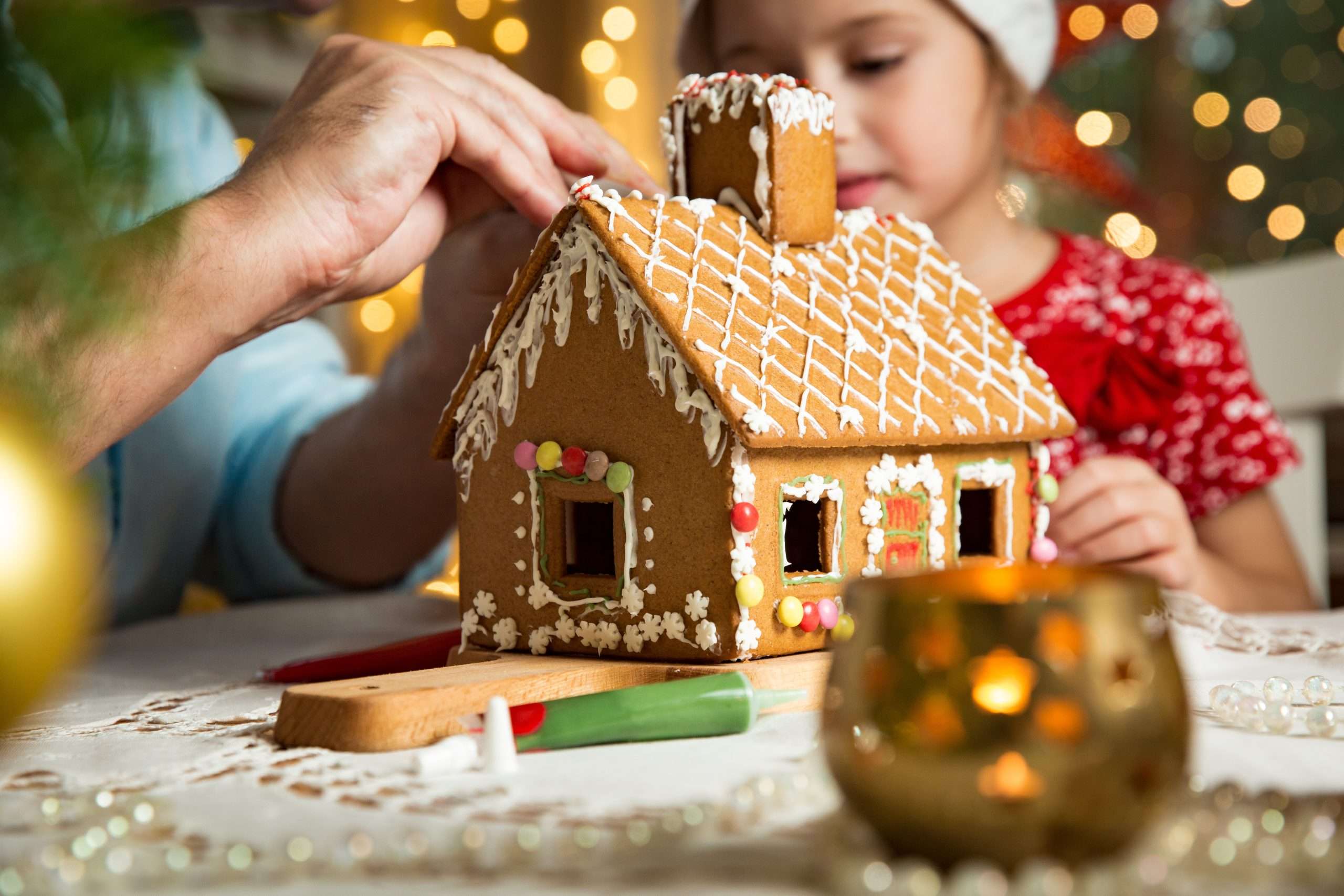 A father and daughter making a Gingerbread House